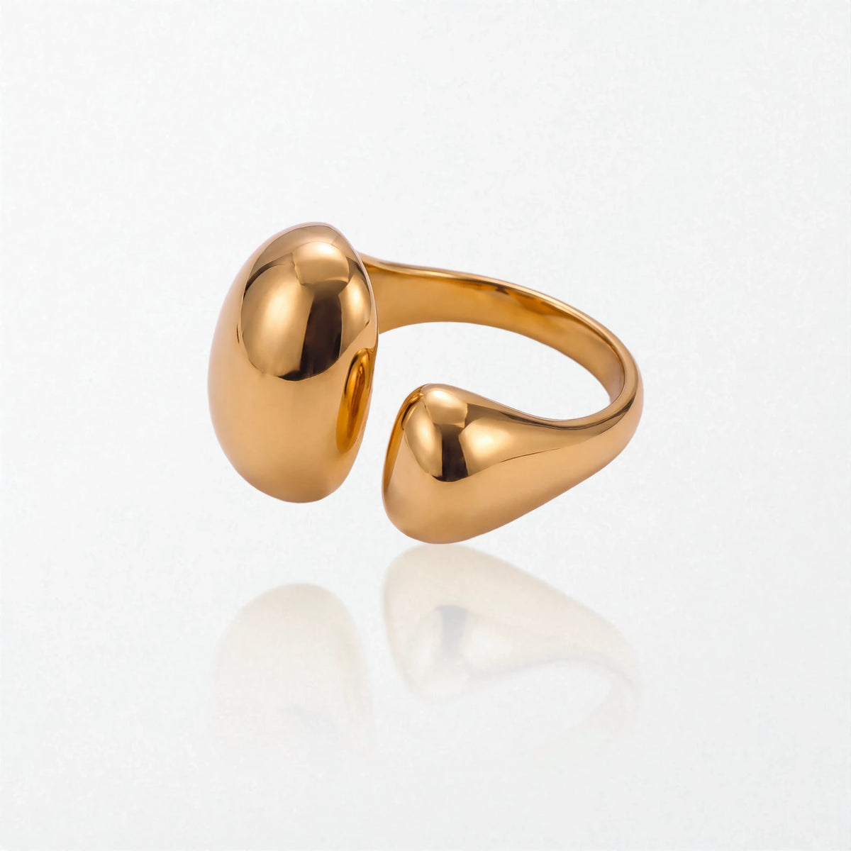 Gold Romy dome ring lying on its side, showing the open adjustable band and both molten domes