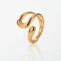 Wren molten wrap ring in 18K gold-plated waterproof stainless steel: one smooth band curling into an open U-shaped loop beside a teardrop tip