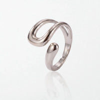 Wren molten wrap ring in polished silver stainless steel, with an open U-shaped loop beside a rounded teardrop tip