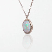Ivy molten opal pendant necklace in polished silver waterproof stainless steel: a milky opal in an irregular silver bezel