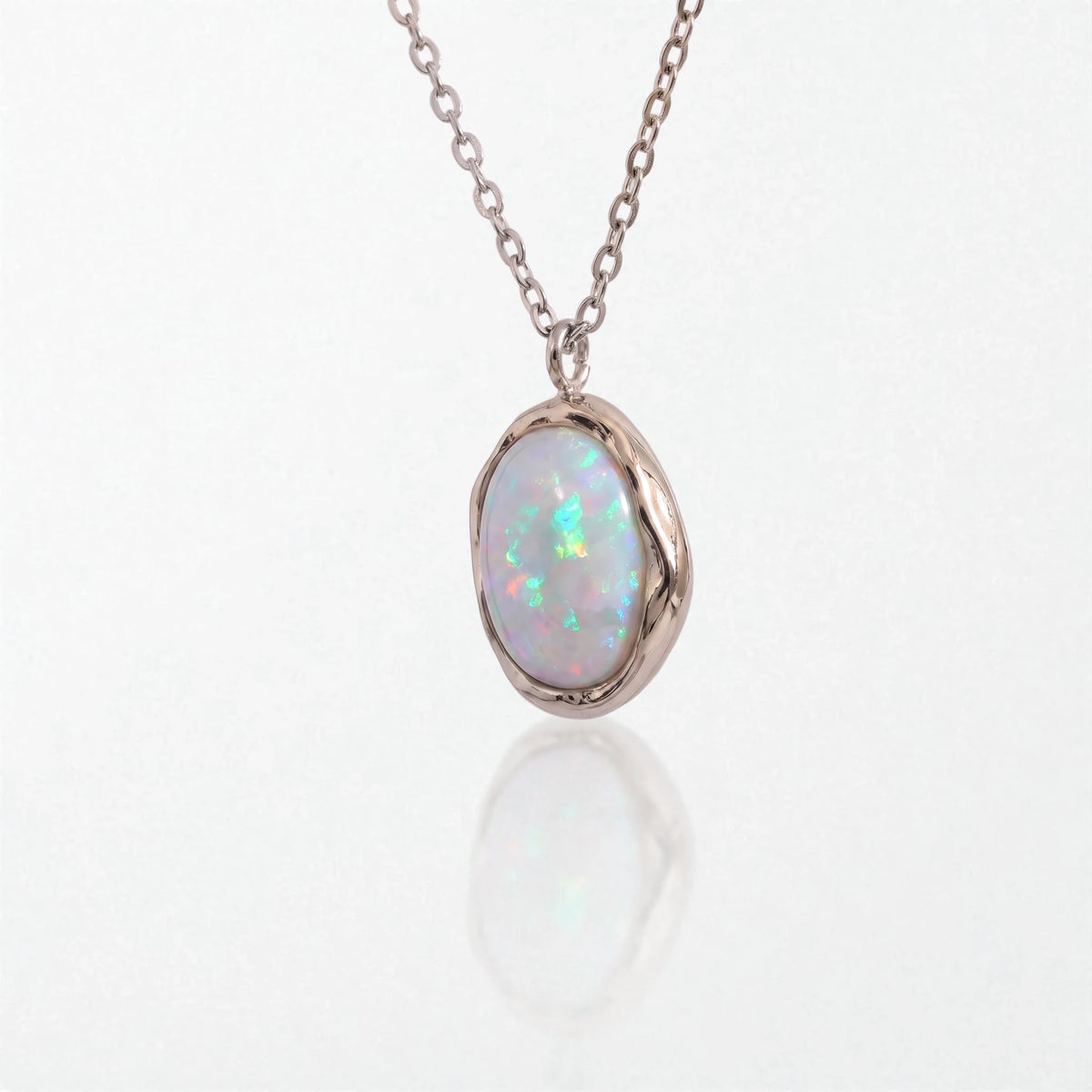 Ivy molten opal pendant necklace in polished silver waterproof stainless steel: a milky opal in an irregular silver bezel