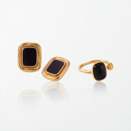 The Noir set: Sabine black square studs and the Odile black obsidian open ring, both in 18K gold-plated waterproof stainless steel