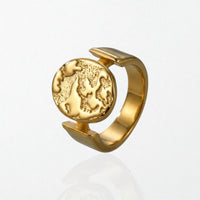 Sculptural statement 18k plated ring with textured globe disc suspended in open band, stainless steel design