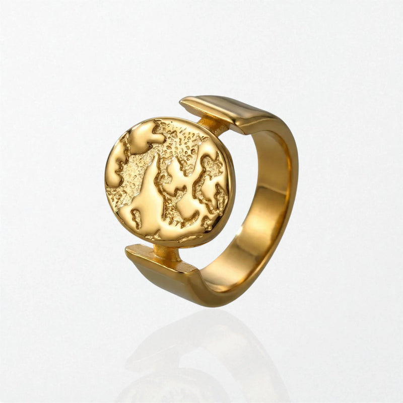 Sculptural statement 18k plated ring with textured globe disc suspended in open band, stainless steel design