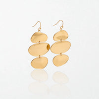 Pair of Greta sculptural triple disc drop earrings in 18K gold-plated waterproof stainless steel, three stacked gold discs on hooks