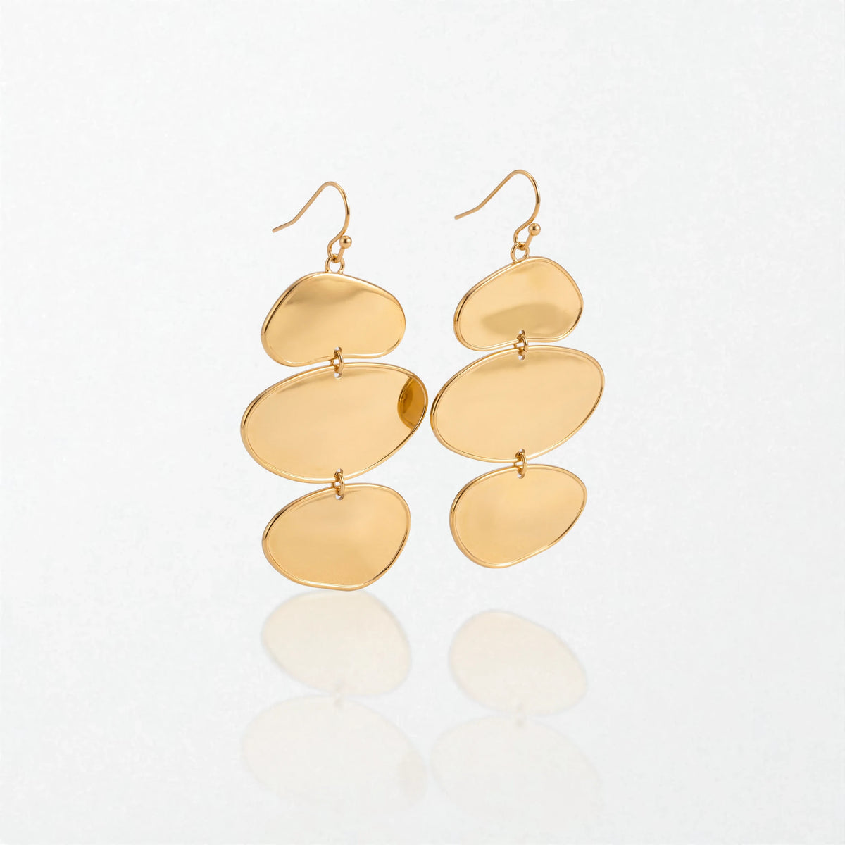 Pair of Greta sculptural triple disc drop earrings in 18K gold-plated waterproof stainless steel, three stacked gold discs on hooks