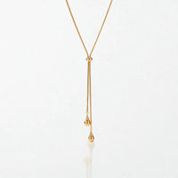 Elodie Y lariat necklace in 18K gold-plated waterproof stainless steel: a fine snake chain through a slider bead, ending in two teardrops