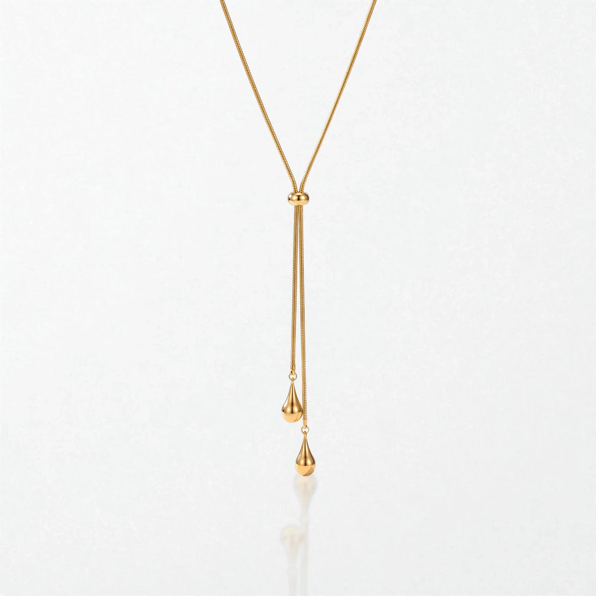 Elodie Y lariat necklace in 18K gold-plated waterproof stainless steel: a fine snake chain through a slider bead, ending in two teardrops
