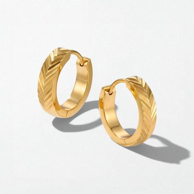 Pair of Ingrid textured chevron huggie earrings in 18K gold-plated waterproof stainless steel, with a chevron-ridged finish