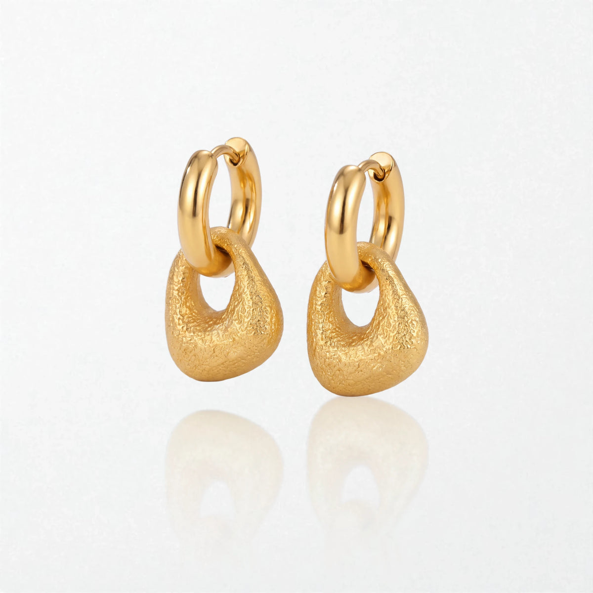 Pair of Agnes textured molten drop huggies in 18K gold-plated waterproof stainless steel, with a brushed, rounded drop under a hoop