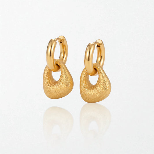 Pair of Agnes textured molten drop huggies in 18K gold-plated waterproof stainless steel, with a brushed, rounded drop under a hoop