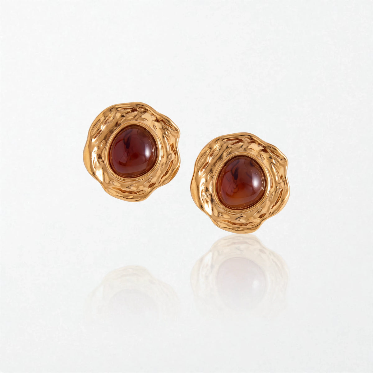 Pair of Naomi vintage stud earrings: deep cognac amber stones set in wide, hammered 18K gold-plated stainless steel frames